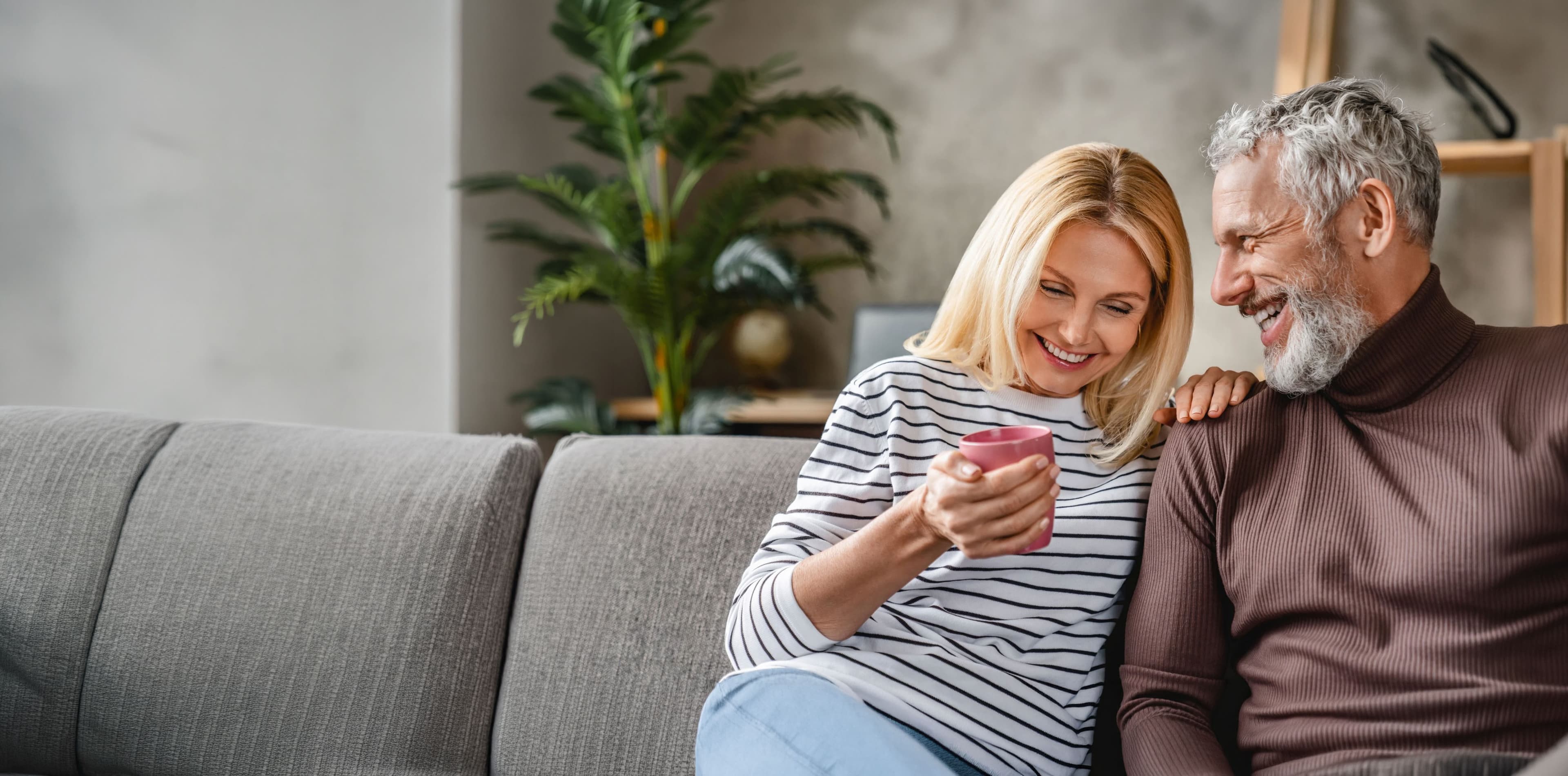 Hero image of a smiling person with dental implants